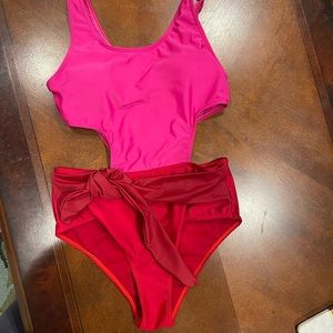 One piece size medium bathing suit with side cut out and waist tie
